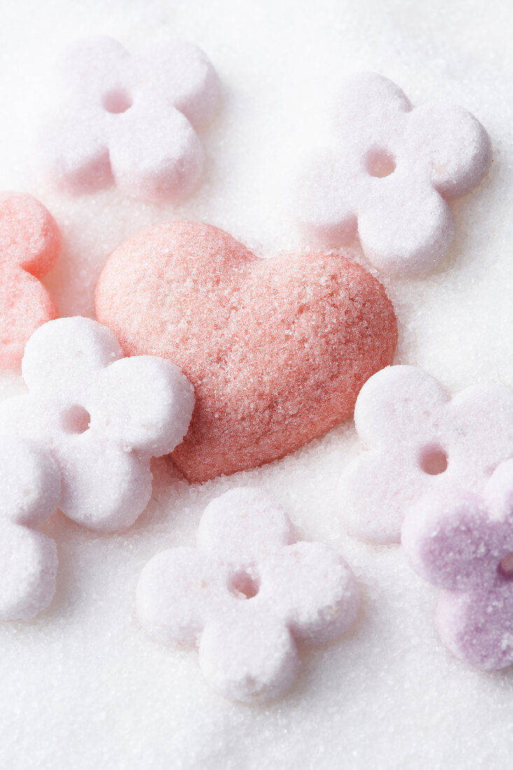 Close-up of red sugar heart with colorful flowers made of sugar
