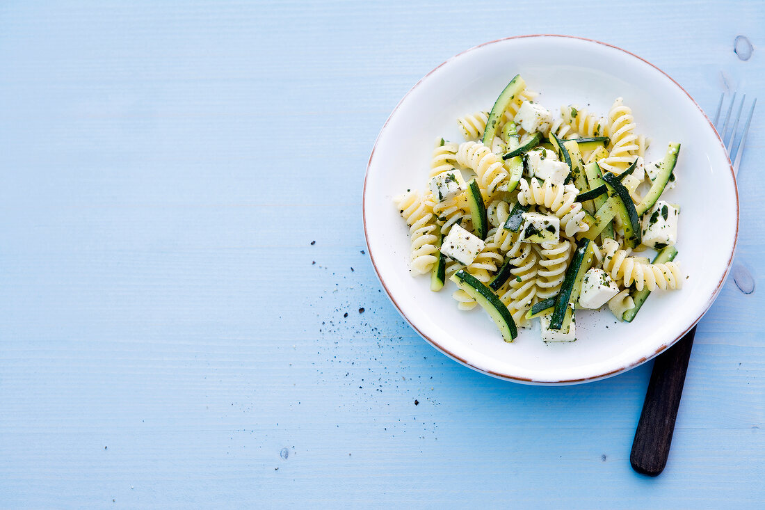 Salad with zucchini, noodle, feta and pasta spirals on plate