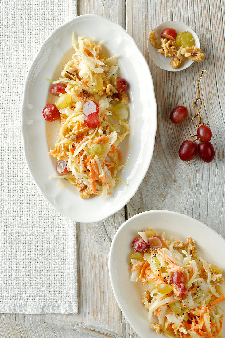 Coleslaw salad in serving plate on wooden surface