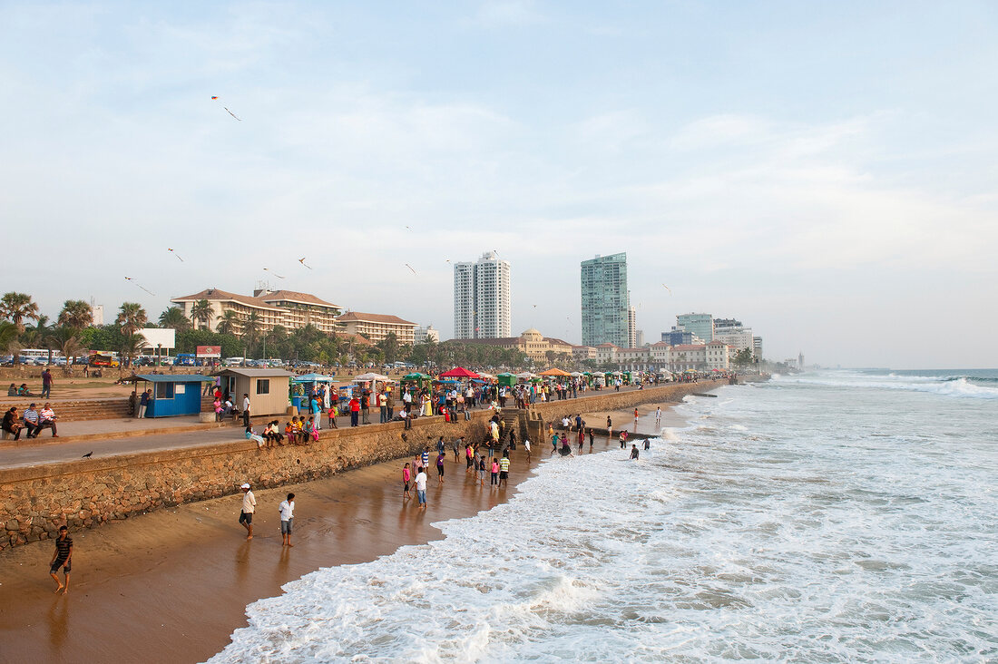 People at promenade, enjoying on beach in front of Galle Face Hotel, Colombo, Sri Lanka
