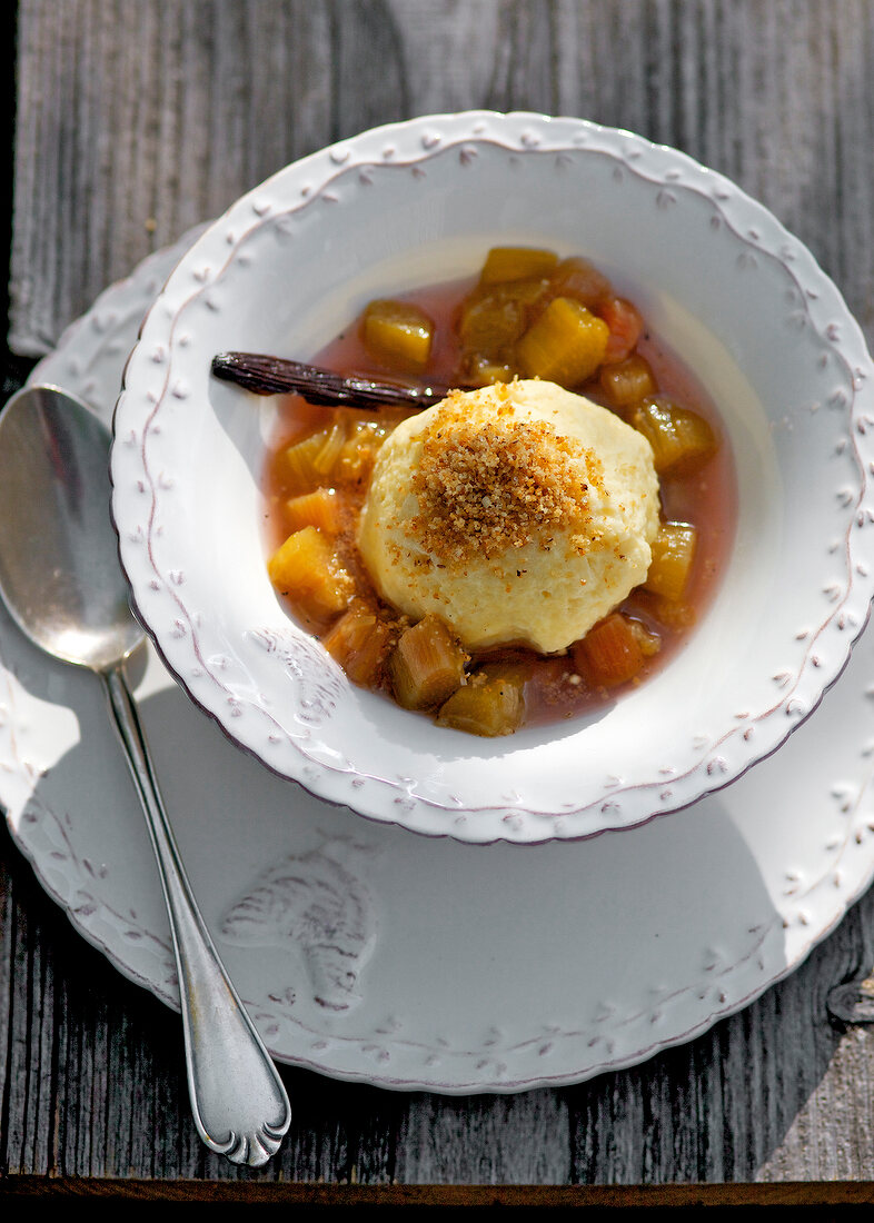 Cheese dumplings with rhubarb compote in bowl