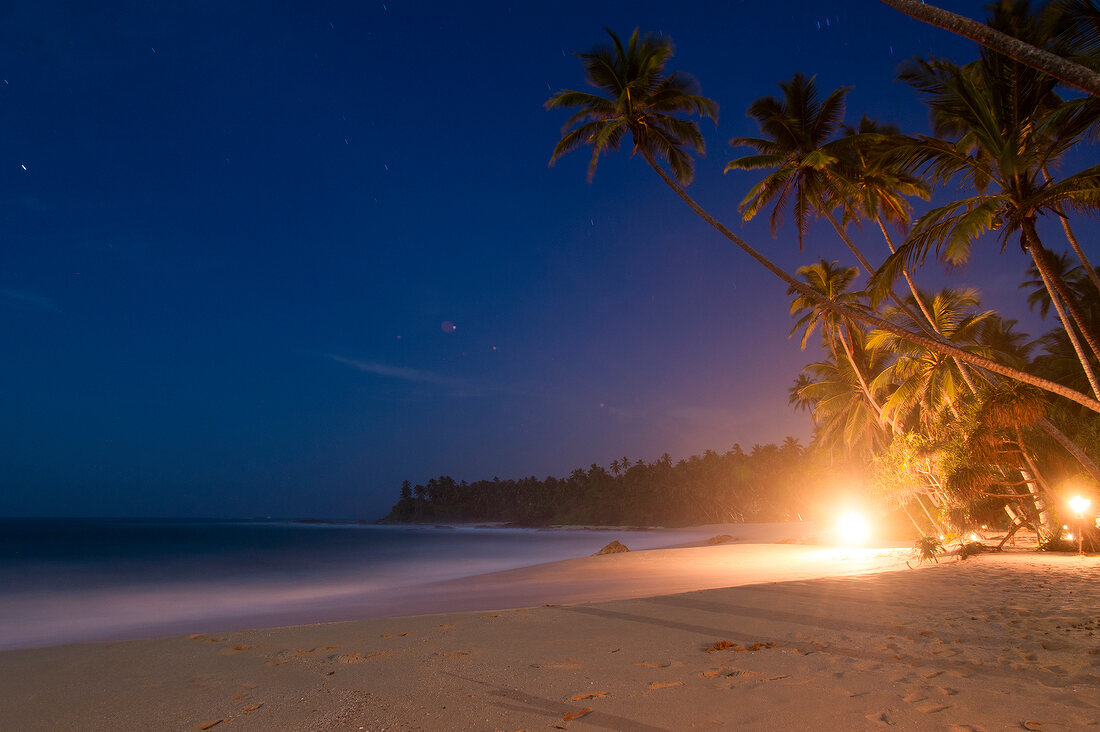 View of beach and palm trees at night in Tangalle, Hambantota District, Sri Lanka