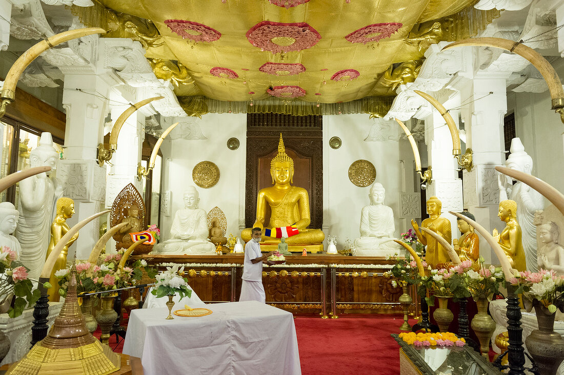 Pilgrims in front of Buddha statue at Sri Dalada Maligawa Temple, Kandy, Sri Lanka