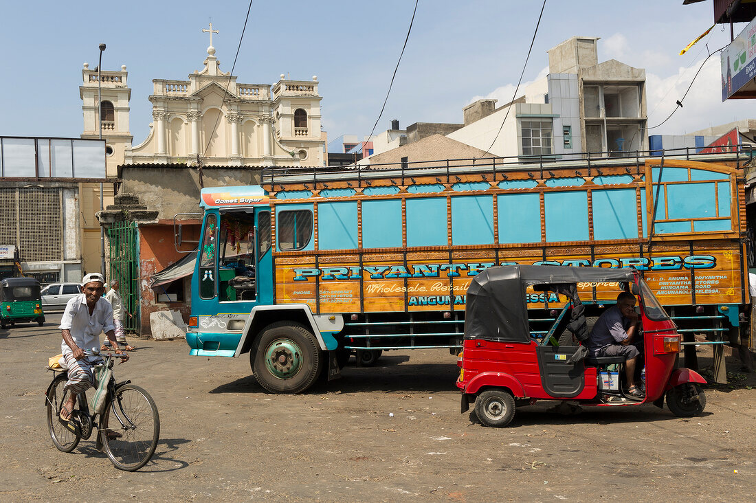 Truck and rickshaw in traffic on street at Colombo, Sri Lanka