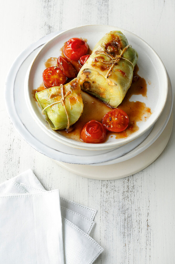 Cabbage rolls with tomatoes on plate