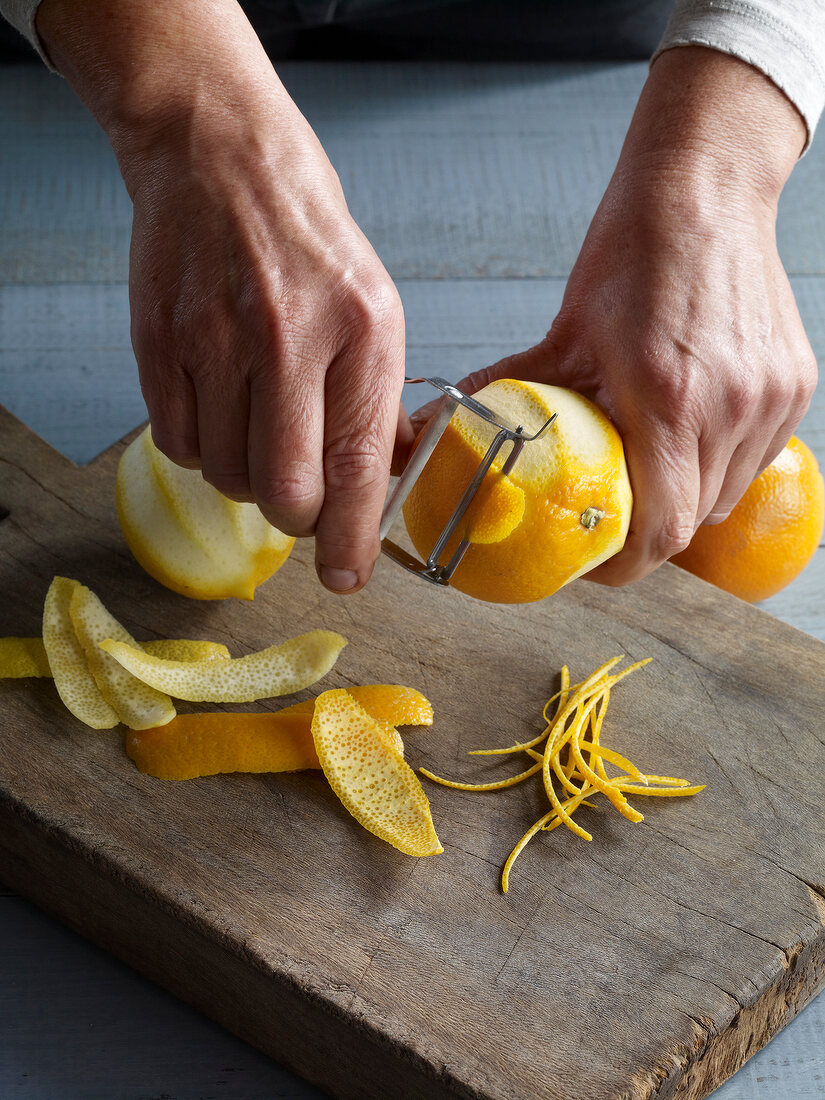Close-up of peeling orange for preparation of marmalade