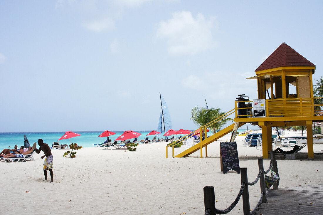 View of tourists and beach house on Lesser Antilles at Caribbean island, Barbados
