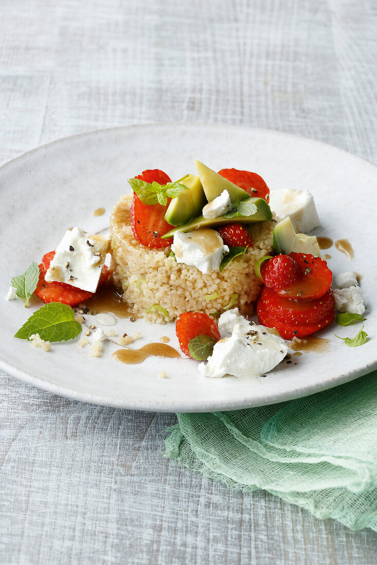 Close-up of couscous with strawberries on plate
