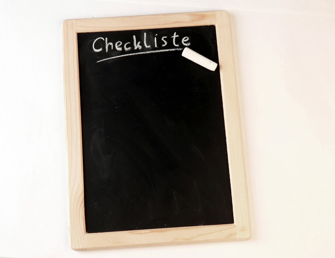 Slate blackboard with note written by chalk, checklist