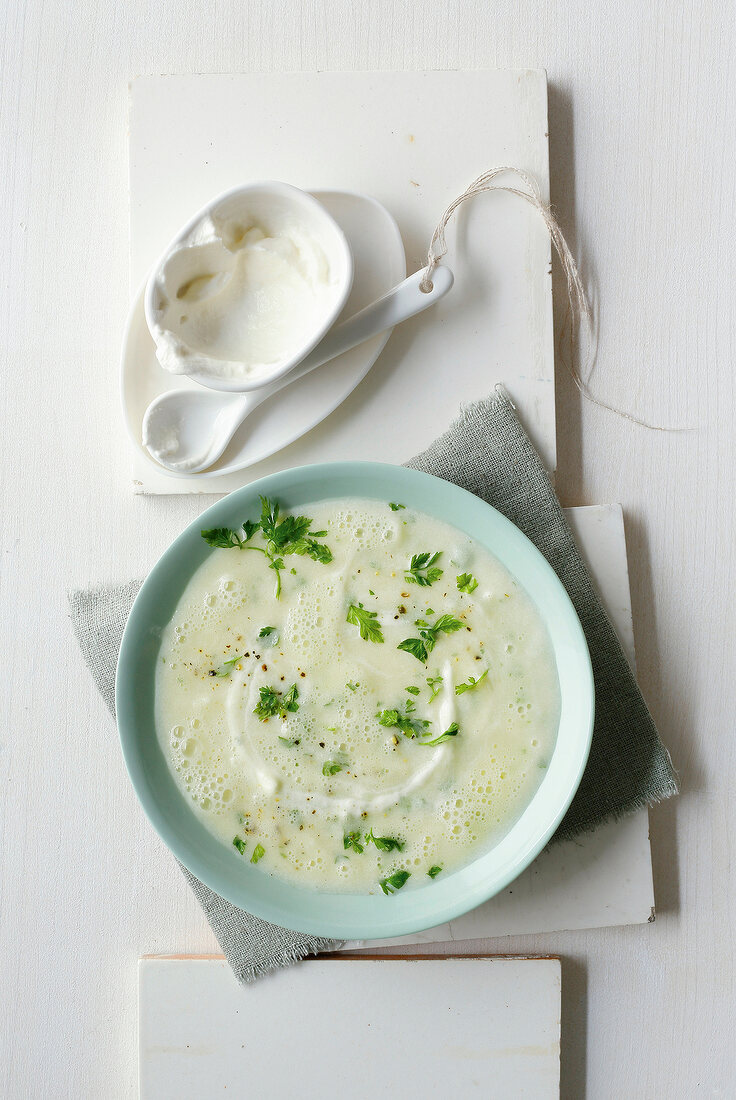 Cream of celery with chervil on serving dish, overhead view