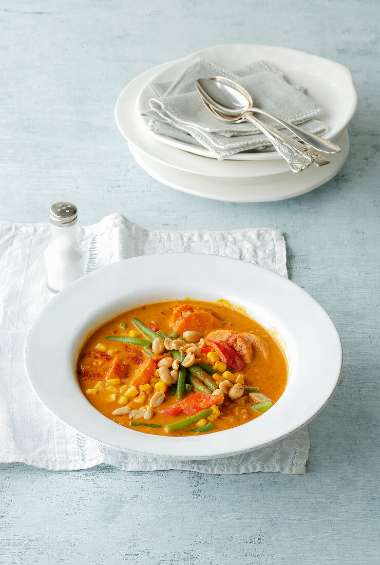 Chili curry with beans in serving bowl on tablecloth