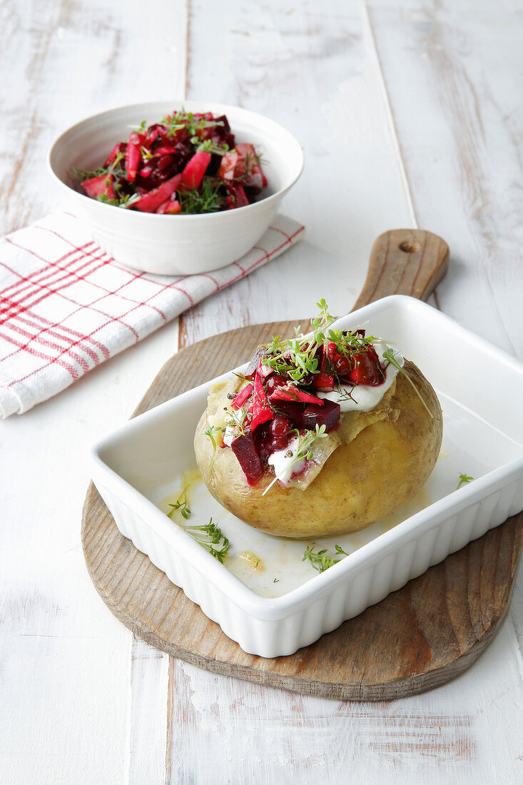 Baked potatoes served with horseradish dip in dish