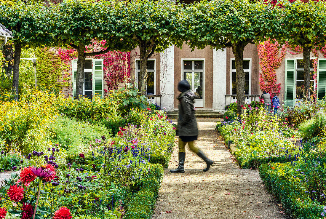 Woman walking in garden at Liebermann Villa, Wannsee, Berlin, Germany