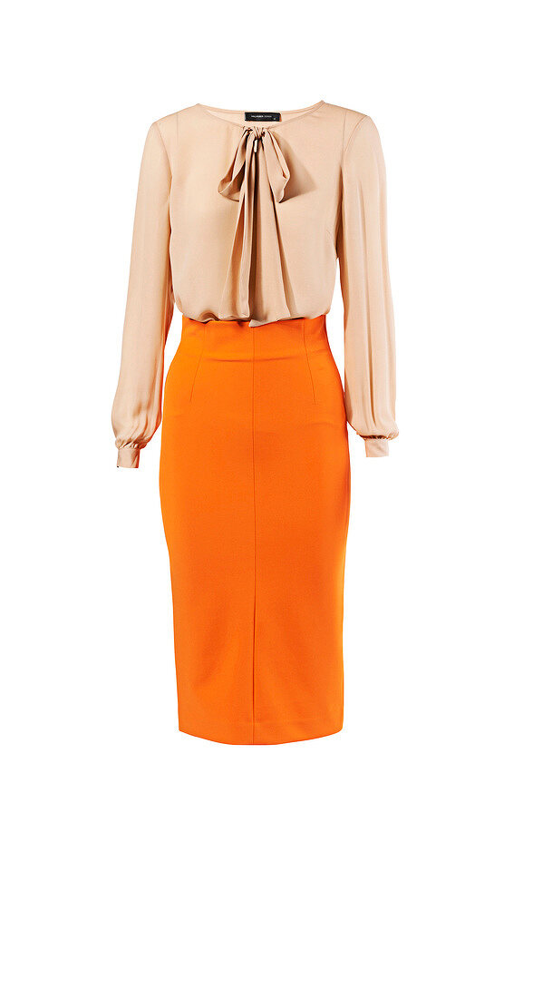 Peach blouse and orange pencil skirt for office wear against white background