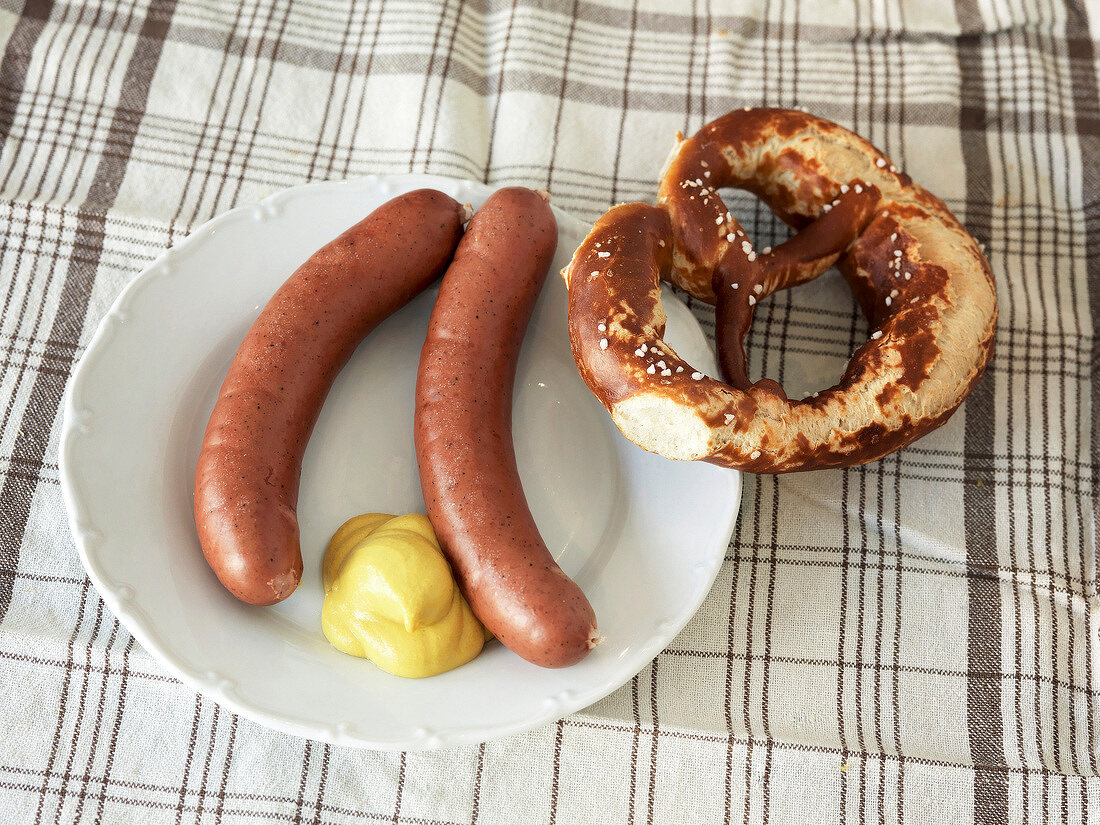 Horsemeat sausages on plate with pretzel