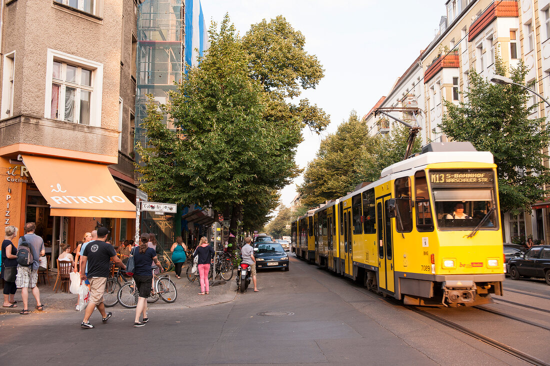 Yellow trum with people on street in Friedrichshain, Berlin, Germany