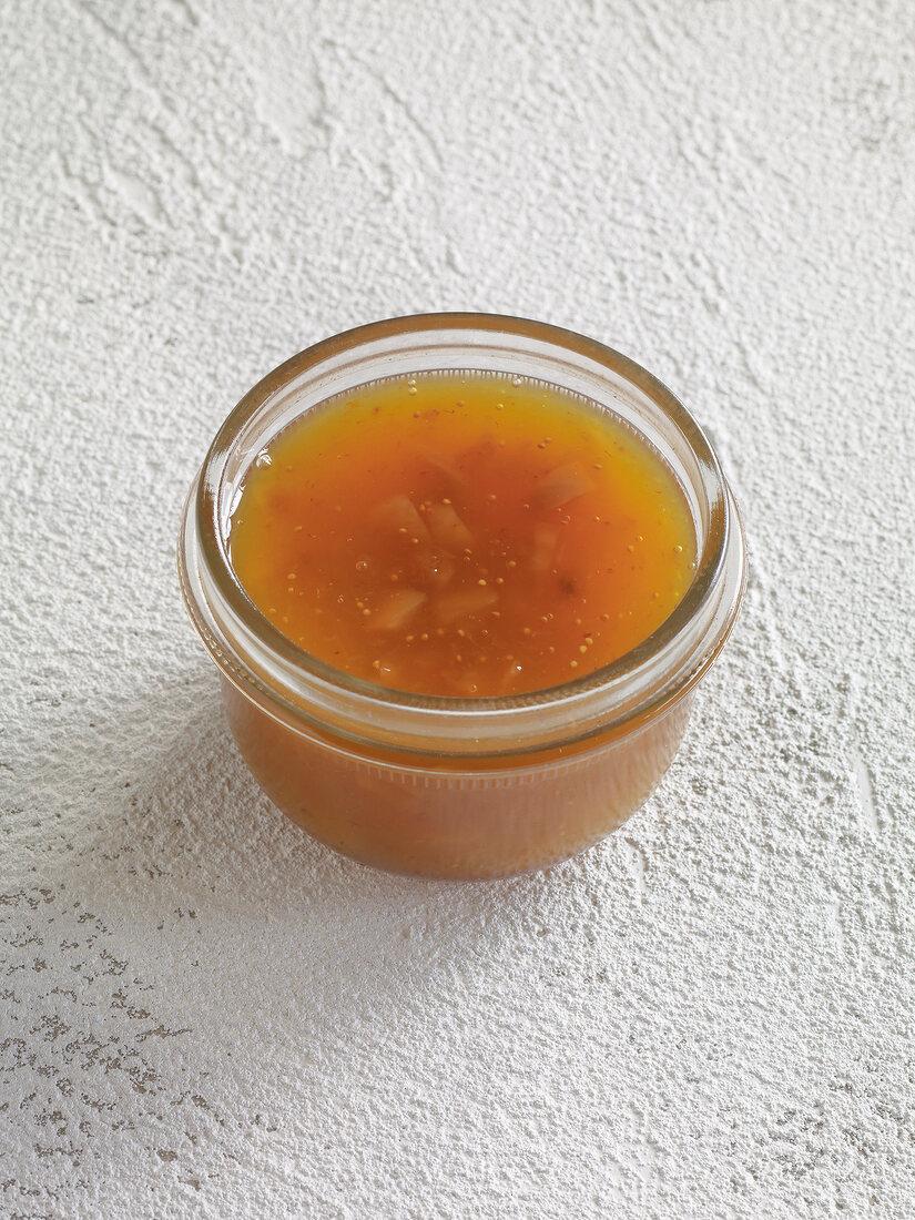 Orange jelly with figs in glass jar