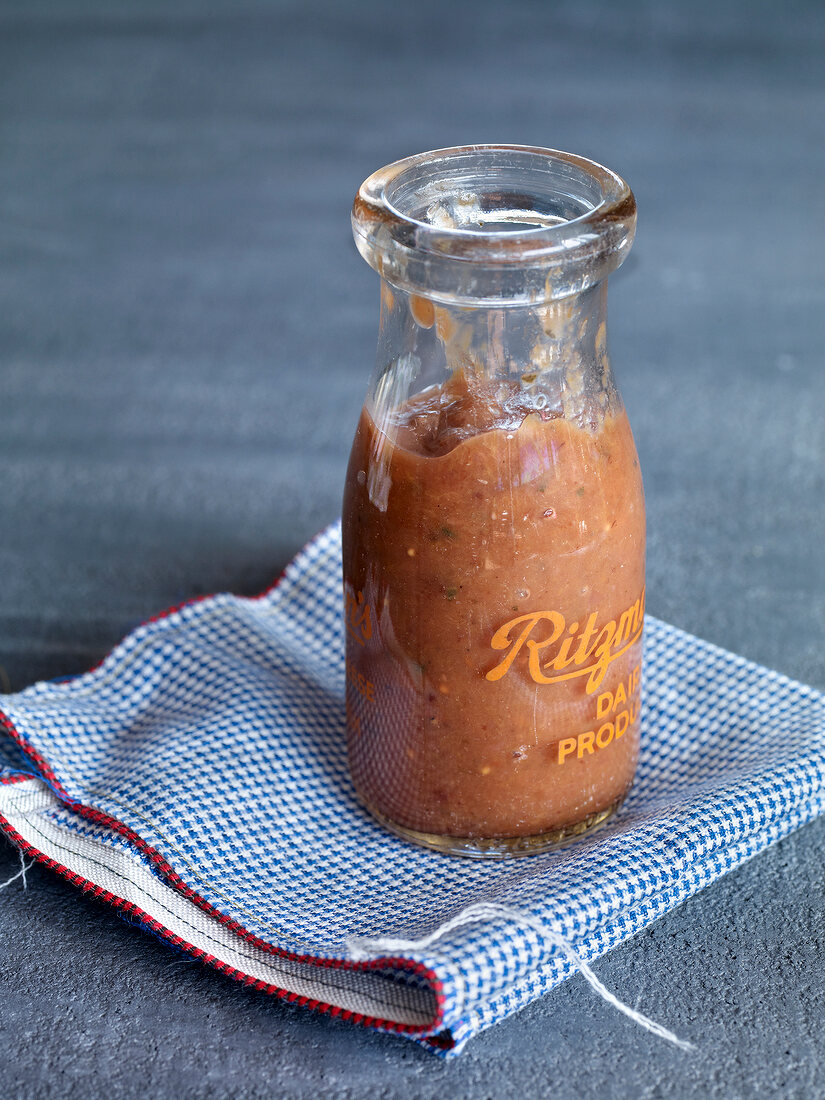 Jar of plum ketchup on napkin