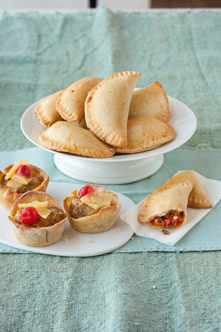 Empanadas and muffins on plate
