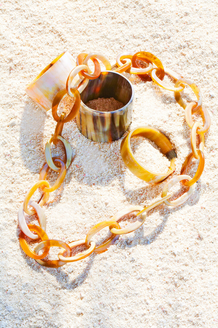 Jewellery made from buffalo horn on sand