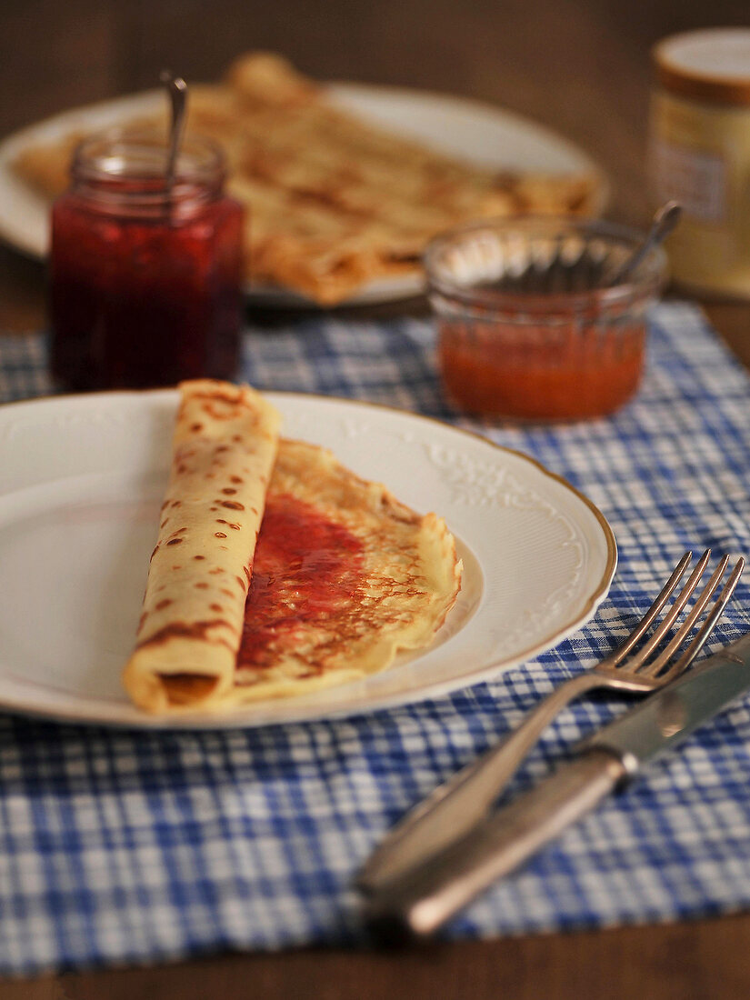 Pancakes with jam and marmalade on plate