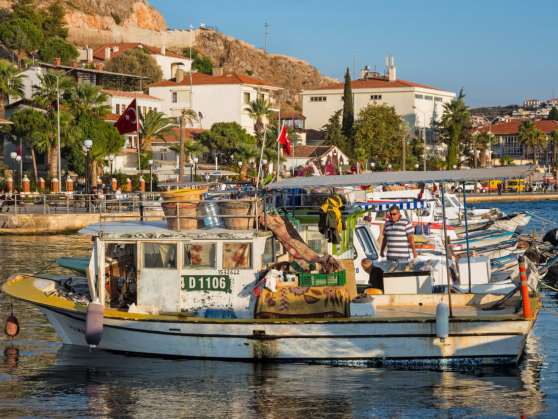 Man on fishing boat at harbor in Cesme, Turkey