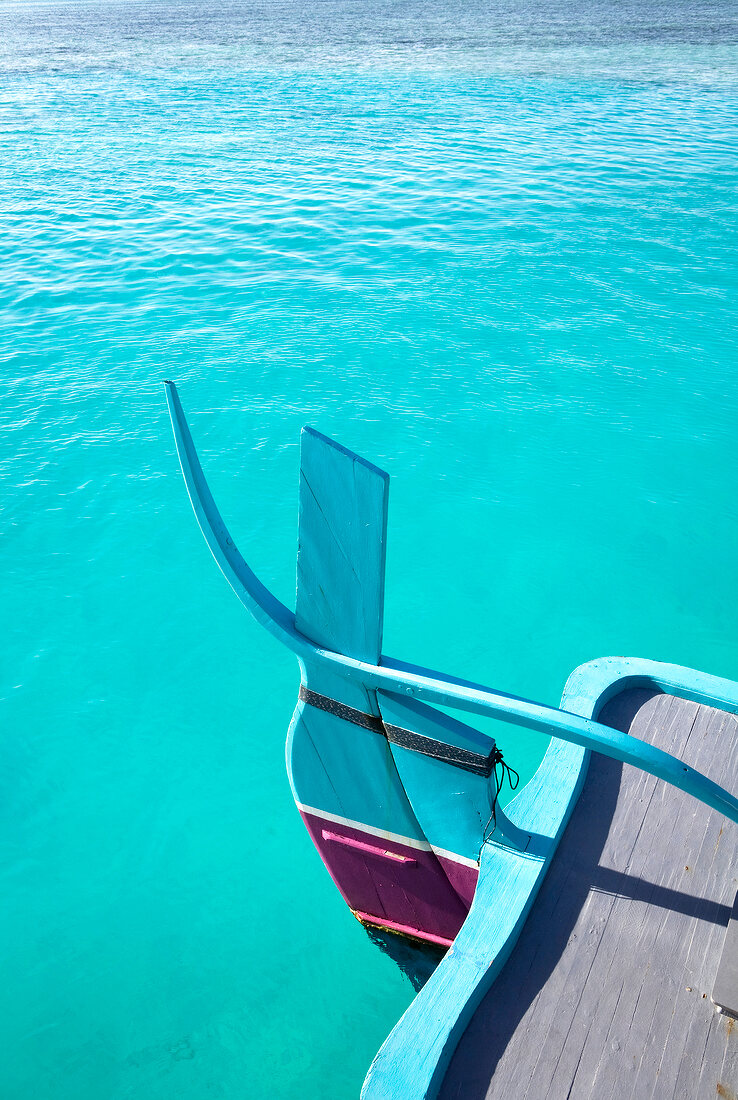 Boat in turquoise sea at island Veliganduhuraa, Maldives