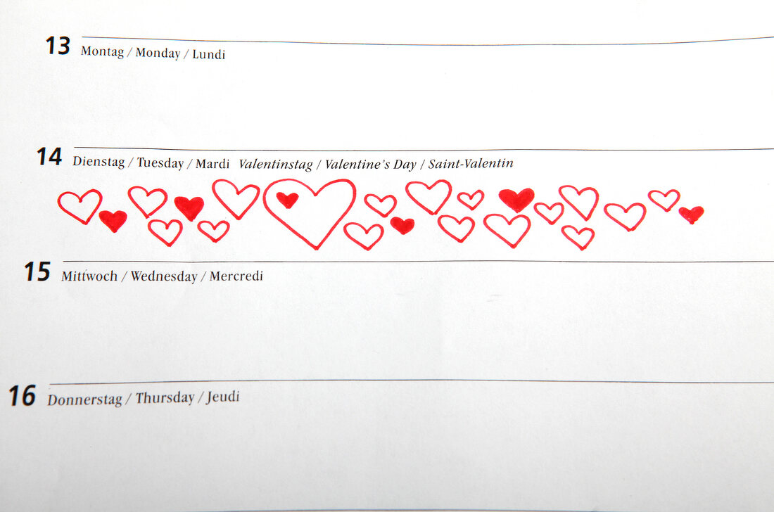 Red hearts drawn on calendar with date of 14th February