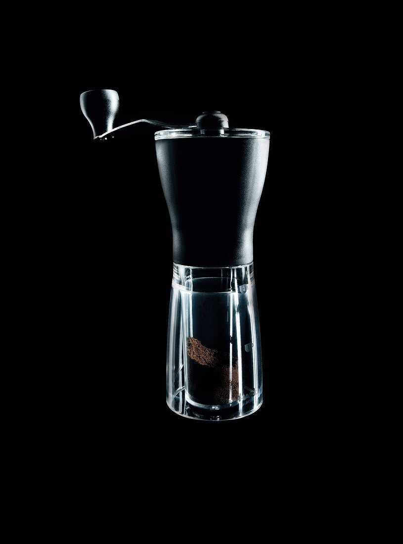 Close-up of coffee grinder against black background