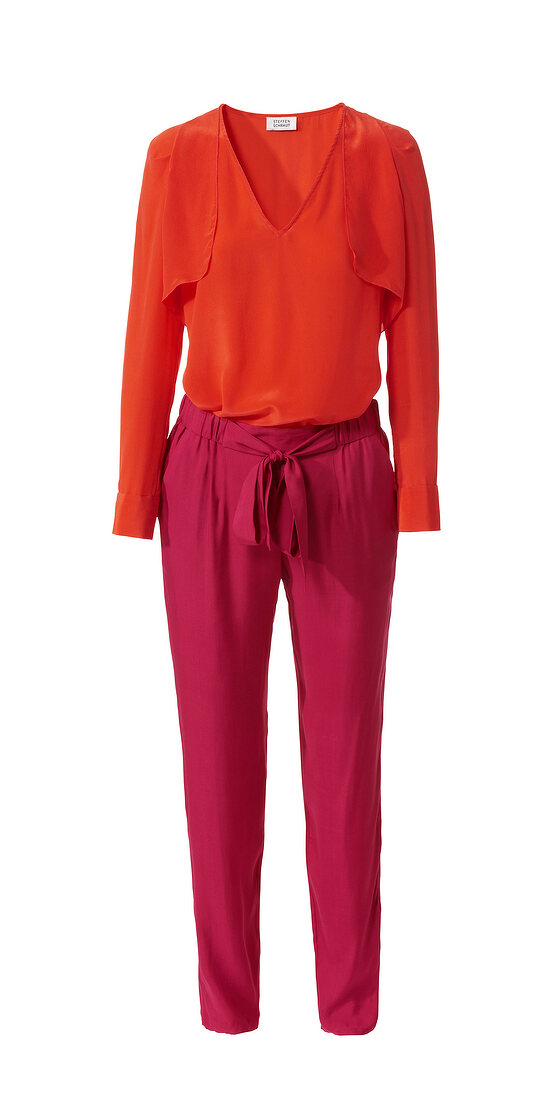 Red chiffon blouse with magenta pleated pants on white background