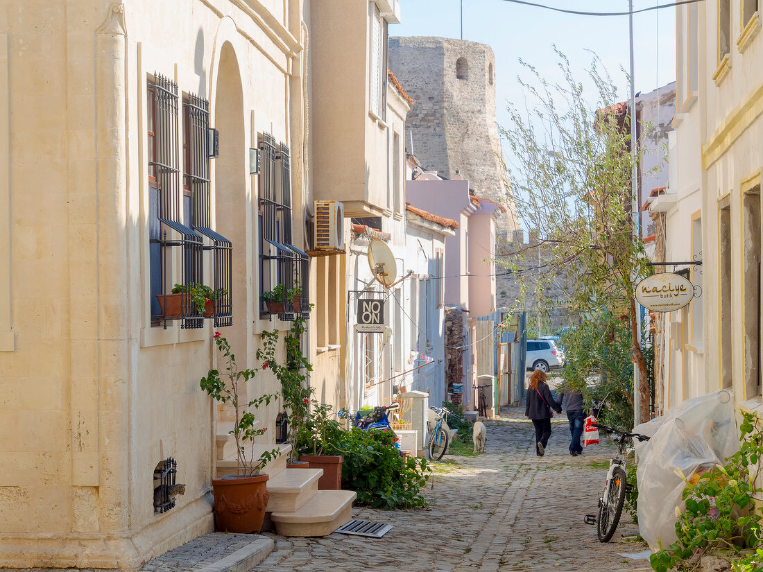 Women walking through alley in Bozcaada, Aegean, Turkey