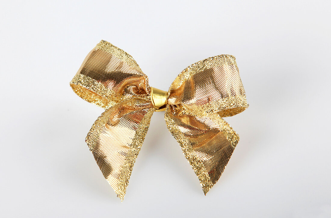 Gold, shiny bow on white background