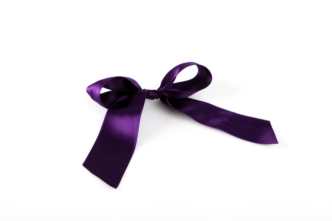 Purple shiny stain bow on white background