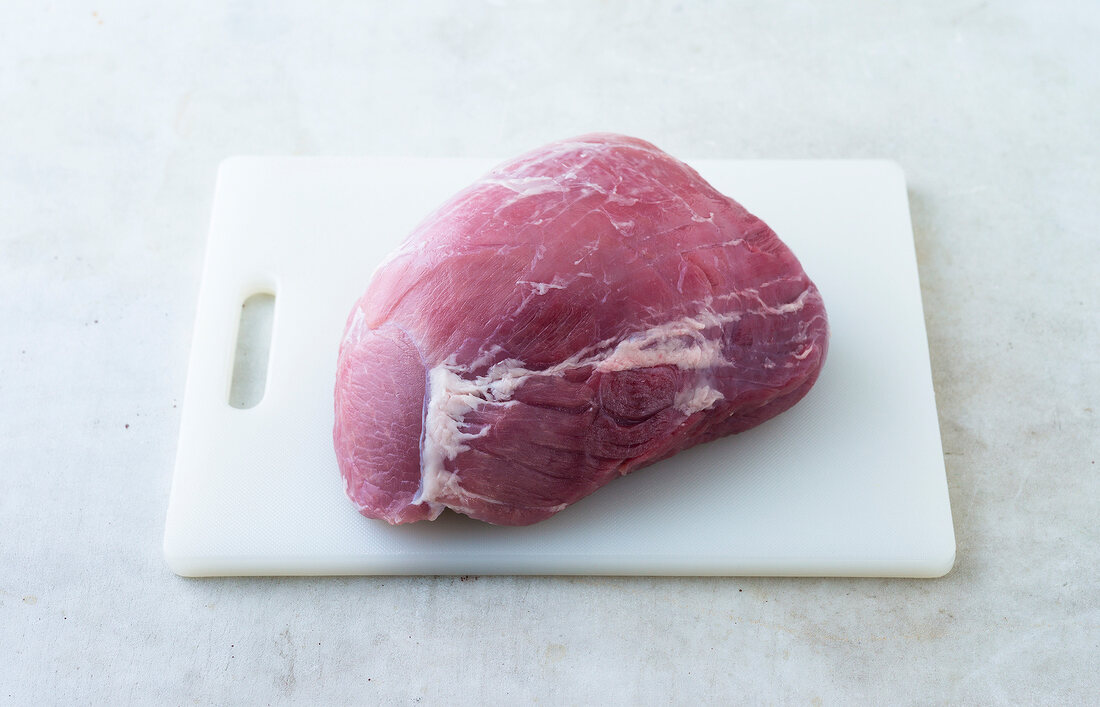 Raw meat on chopping board