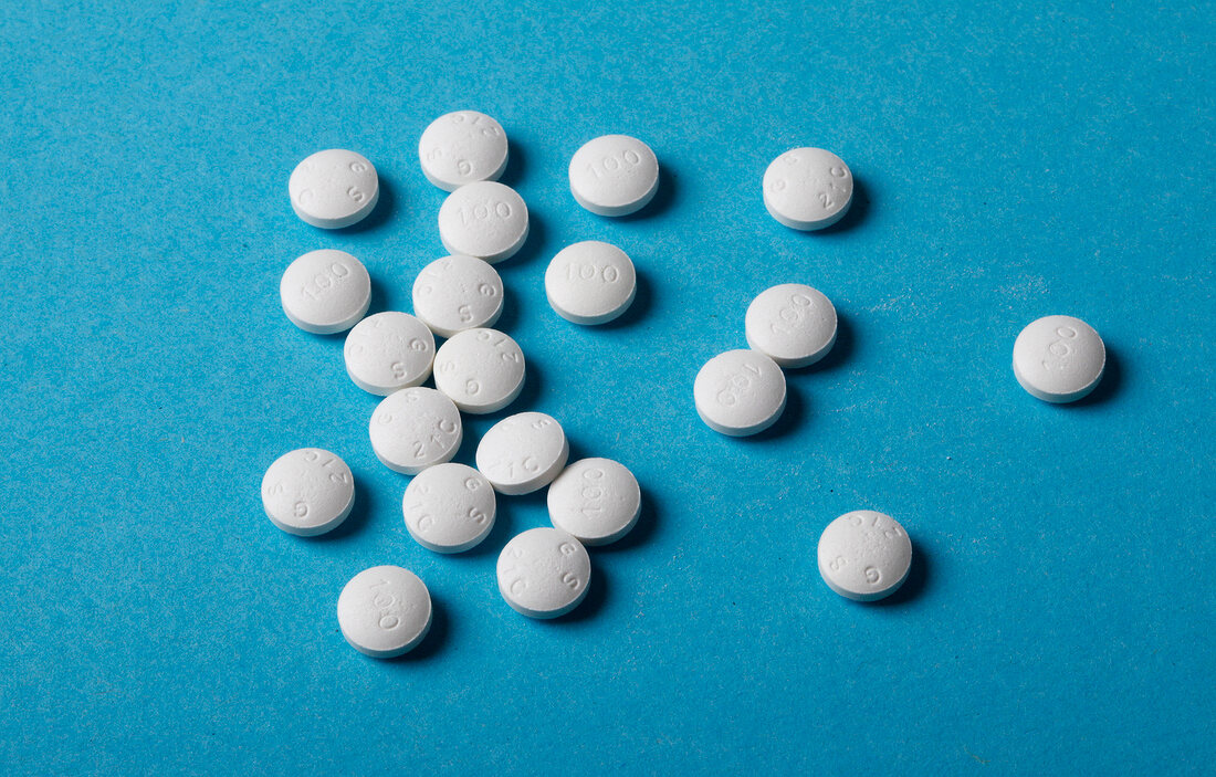 Close-up of white pills against blue background