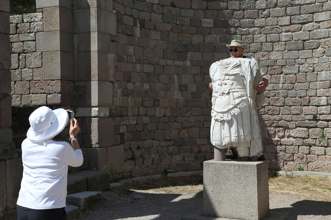 Tourist clicking photographs with ruins in Bergama, Aegean, Turkey
