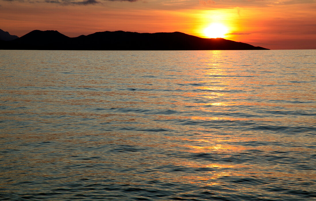 View of sea and mountain at dusk in Dilek Peninsula National Park, Turkey