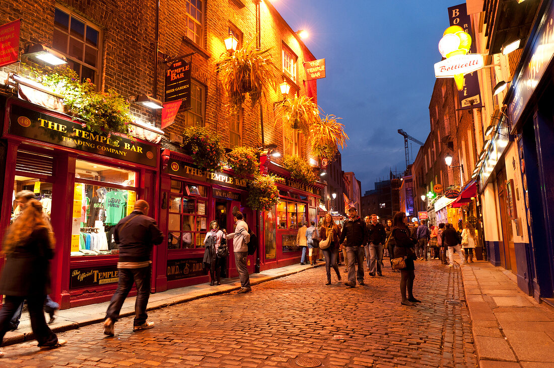 Tourists on street near Temple Bar at night, Dublin, Ireland, UK
