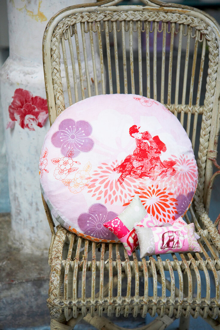 Colourful cushions on wooden chair