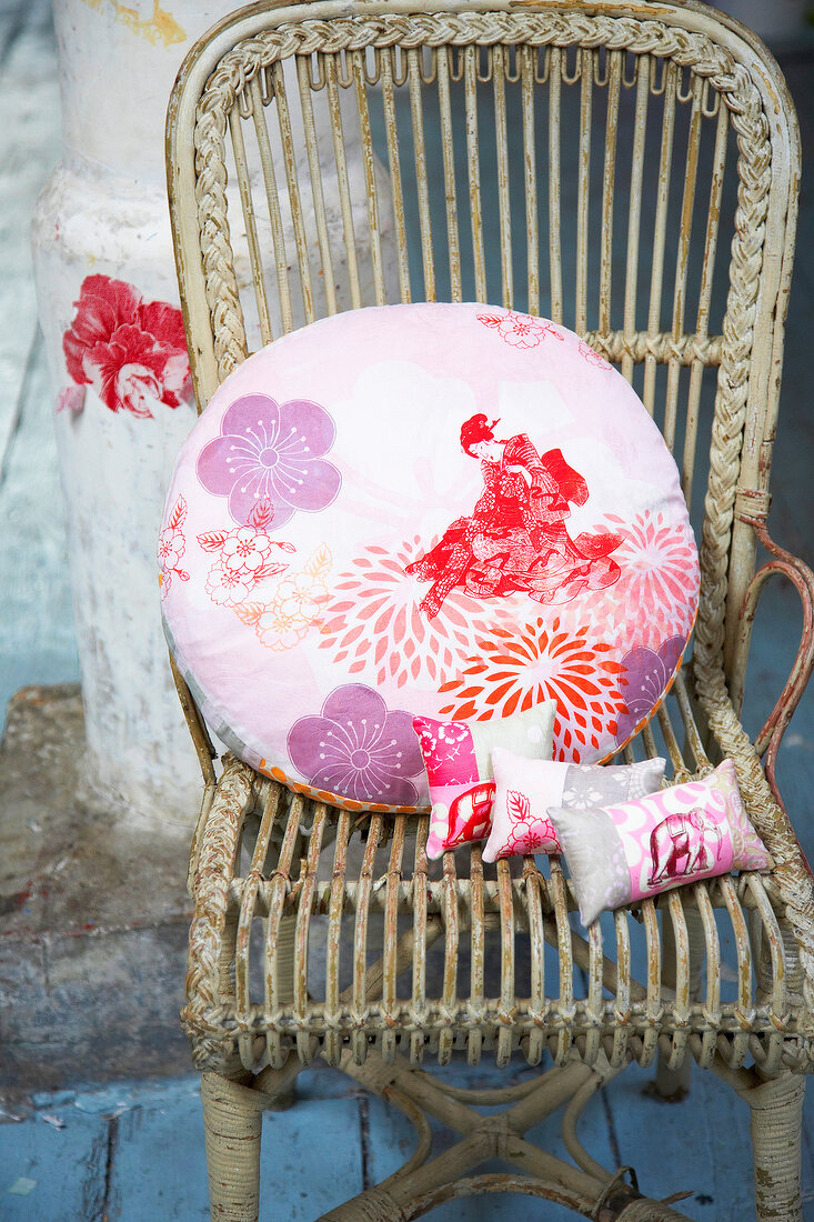 Colourful cushions on wooden chair