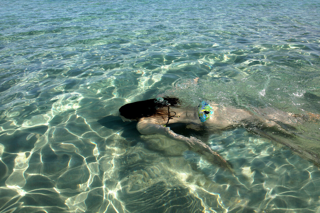 Man lying on Altinkum beach in Alacati, Cesme Peninsula, Turkey