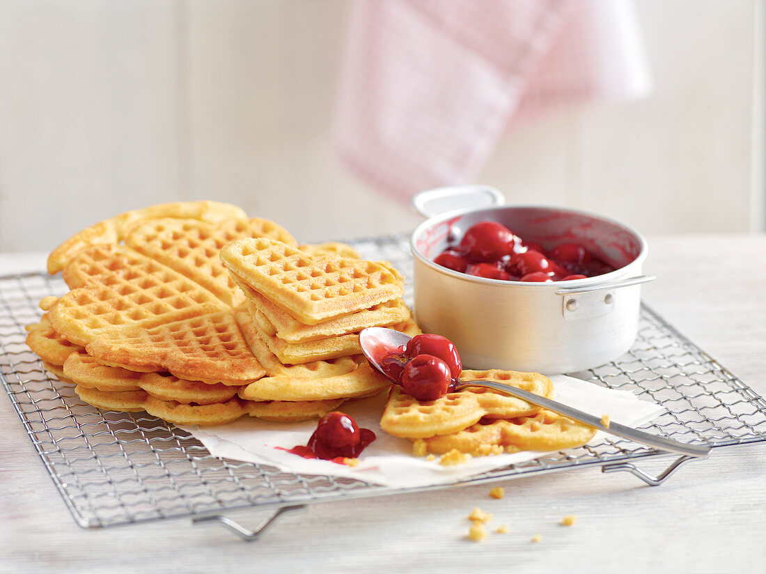 Waffles with sour cherry sauce on cooling rack