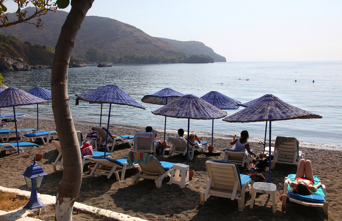 Tourists relaxing on beach of Hayitbuku, Mesudiye, Datca, Turkey