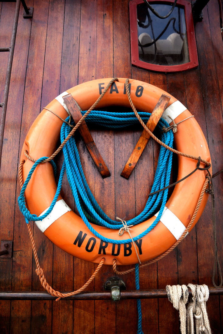 Close-up of life guard ring handing on wooden surface, Fano Nordby, Denmark