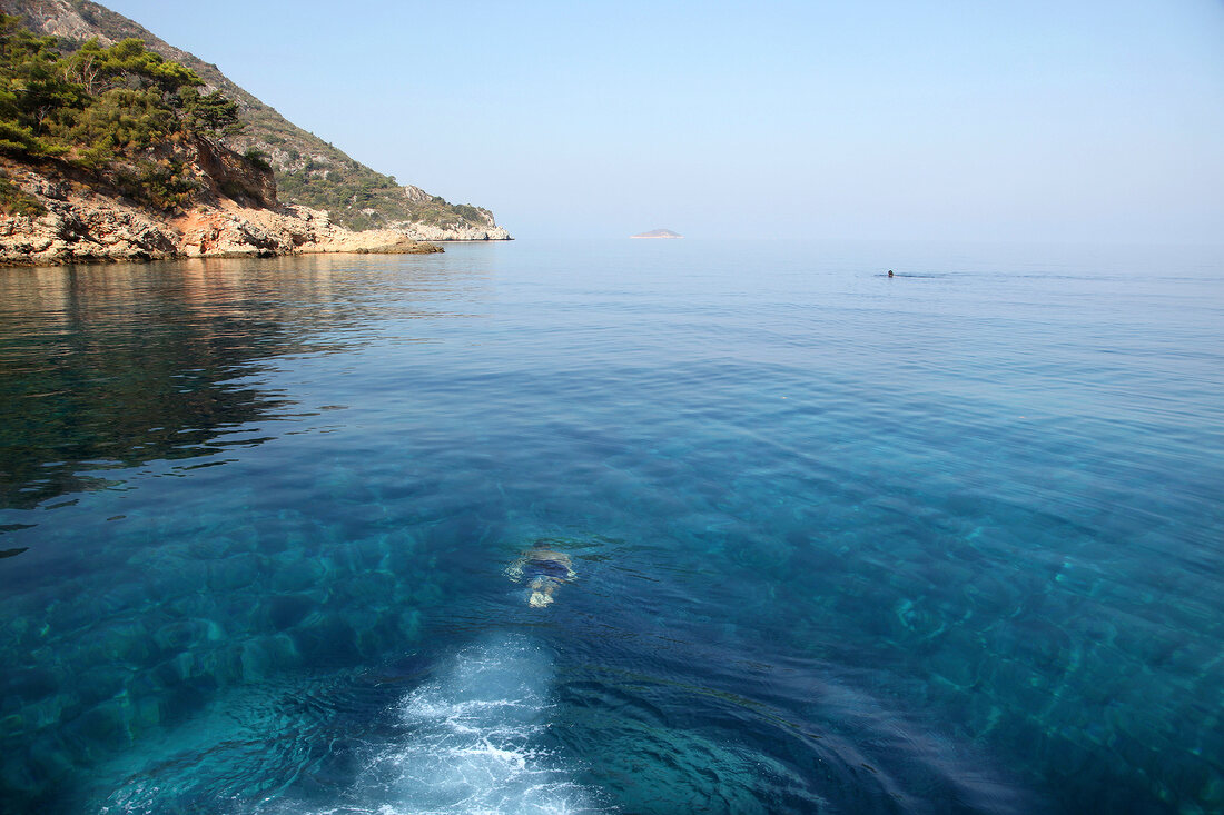 View of landscape with person swimming in Resadiye Peninsula, Turkey