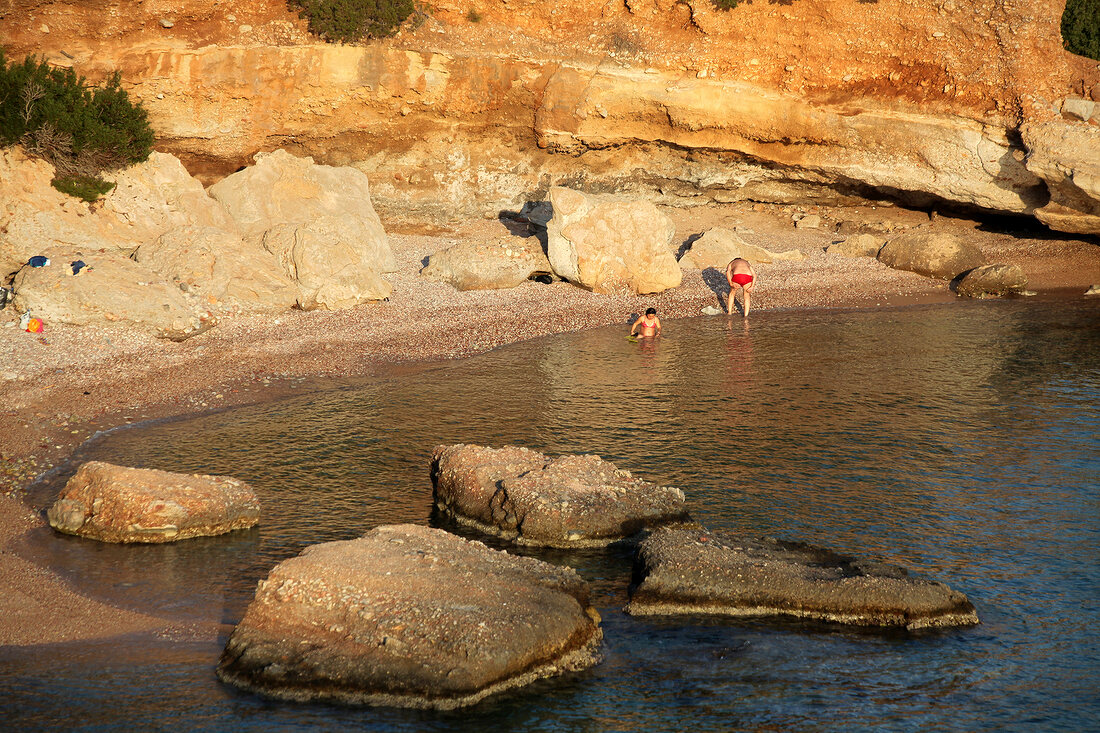 Tourists relaxing on beach between Datca and Knidos, Resadiye Peninsula, Turkey