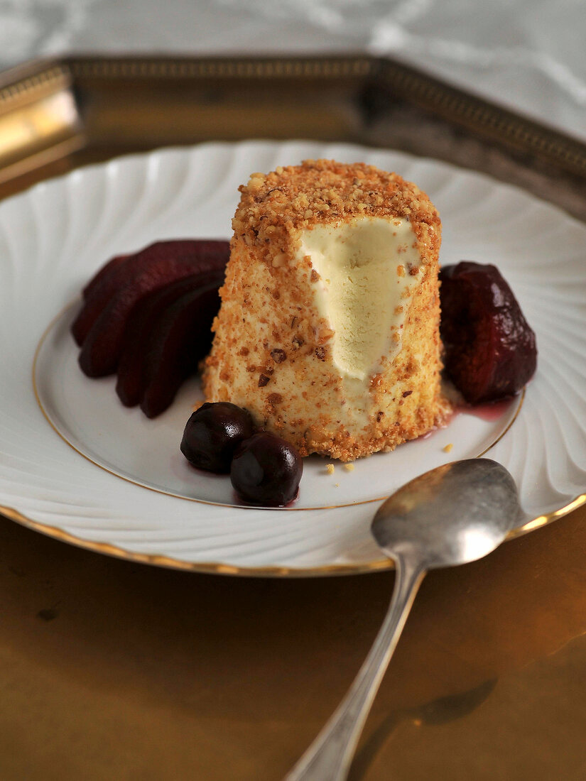 Close-up of goat cheese parfait with cassis fruit on plate