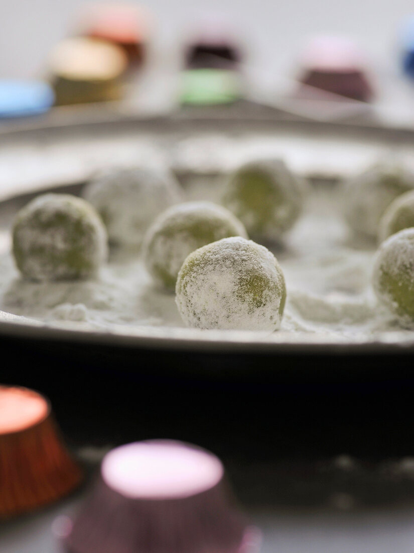 Close-up of green tea truffles with white chocolate