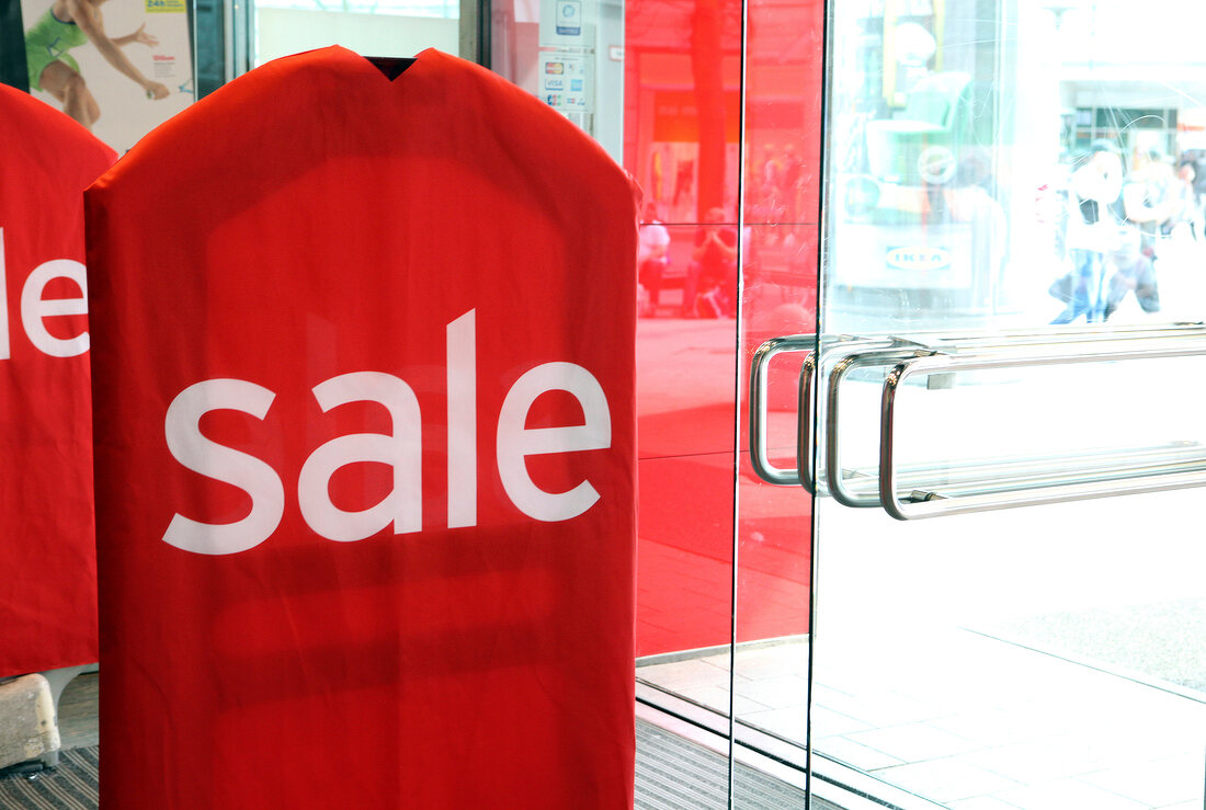 Big red sale signboard at entrance of shop