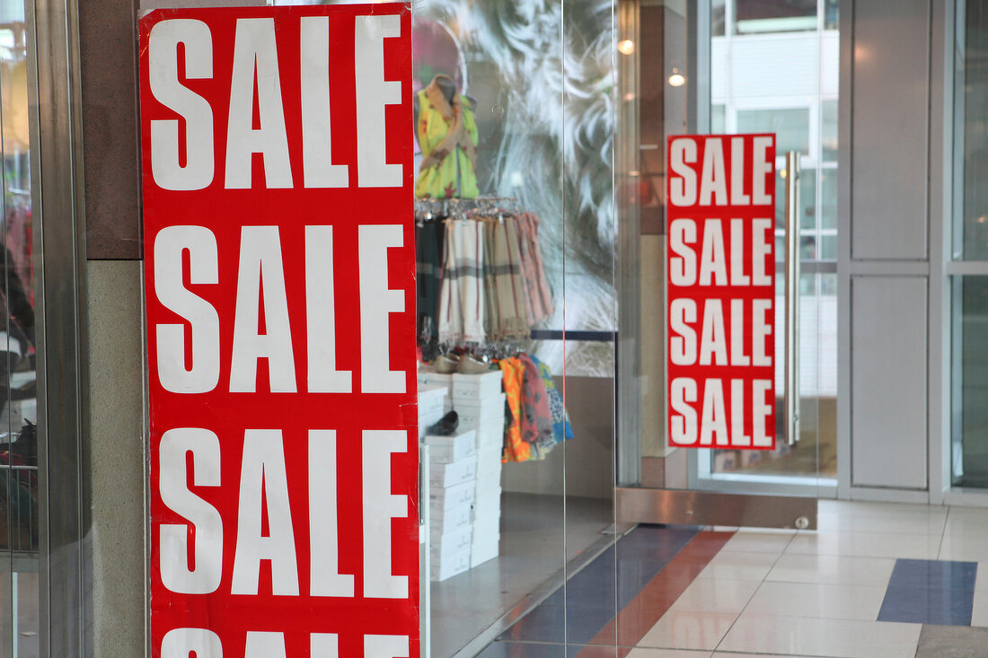 Red sale signboard at entrance of shop